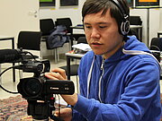 Ein Junge bedient eine Filmkamera