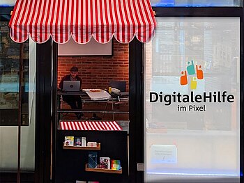 Eingangsbereich des Veranstaltungsortes Pixel mit einem Hinweis auf das Angebot "Digitale Hilfe".