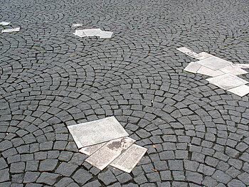 Teile der Flugblätter der Weißen Rose, die als Denkmal auf Boden vor der Universität eingelassen sind.